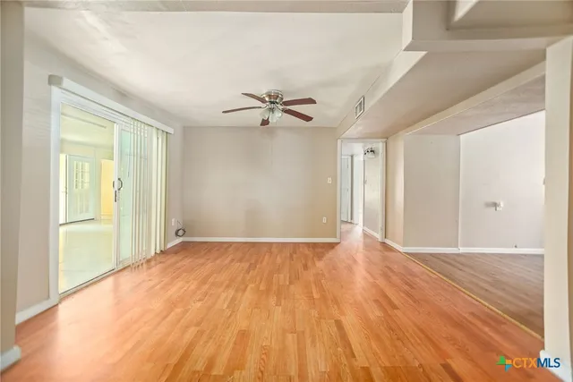 a view of an empty room with a window