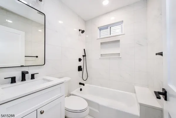 a bathroom with a sink a toilet and a bathtub