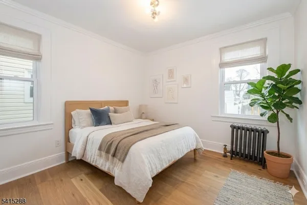 a bedroom with a bed table and a window