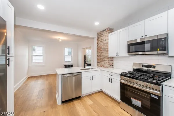 a kitchen with a sink stove and microwave