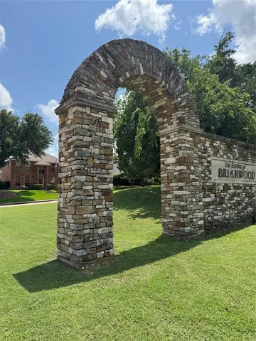 a view of a garden with a building in the background
