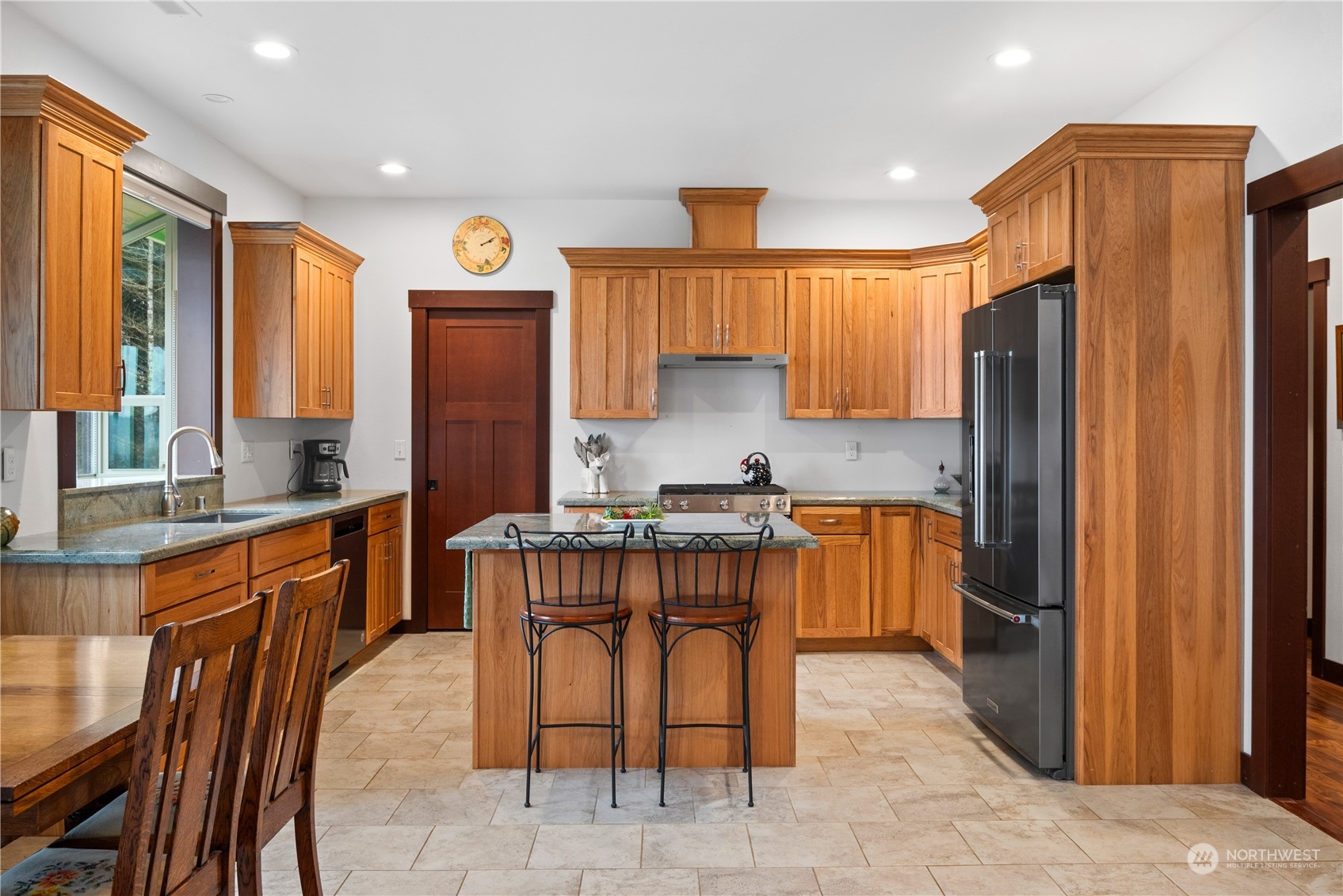3011 Stella Road Longview, WA 98632 - Photo 11 of 38 a kitchen with stainless steel appliances granite countertop wooden cabinets a sink a stove a refrigerator and island