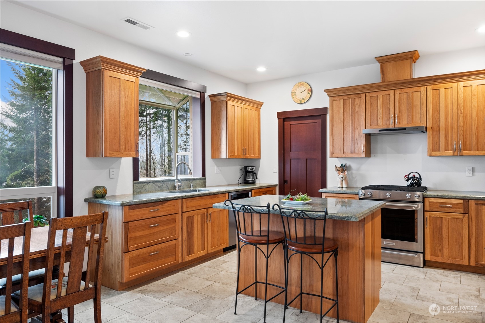 3011 Stella Road Longview, WA 98632 - Photo 12 of 38 a kitchen with stainless steel appliances granite countertop a stove a sink dishwasher and cabinets with wooden floor