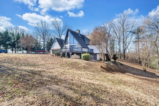 a view of a house with a yard covered in snow