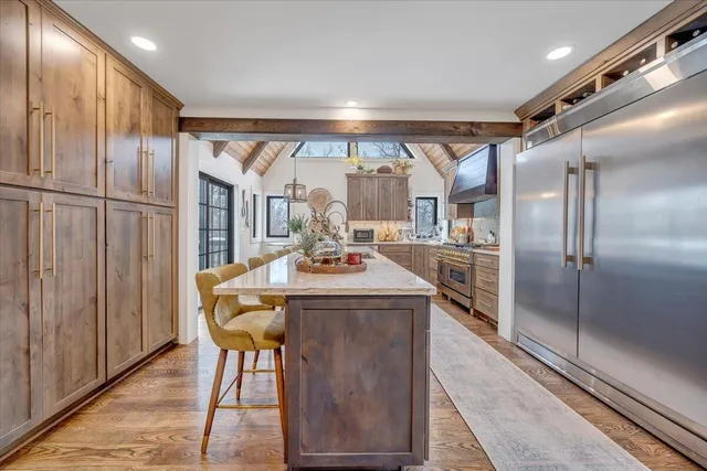 a kitchen with stainless steel appliances a refrigerator and a cabinets