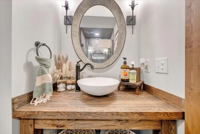 an aerial view of a house with garden space and trees all around