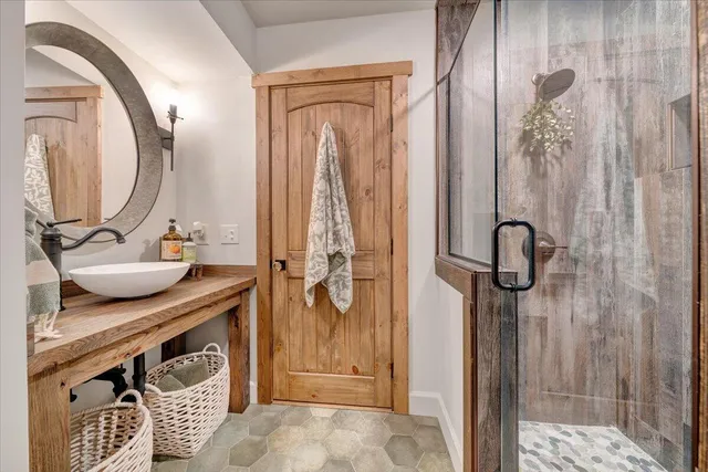 an aerial view of a house with swimming pool and large trees