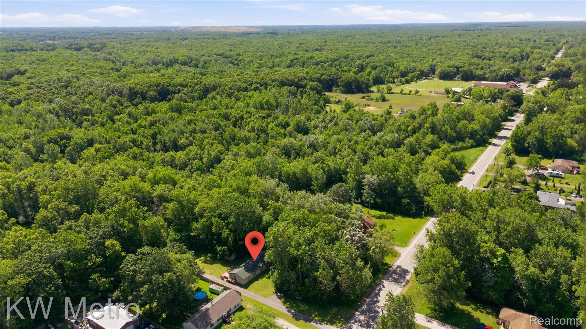 22733 Sumpter Road Belleville, MI 48111 - Photo 50 of 52 Expansive aerial perspective showcasing a property surrounded by abundant mature trees and verdant foliage