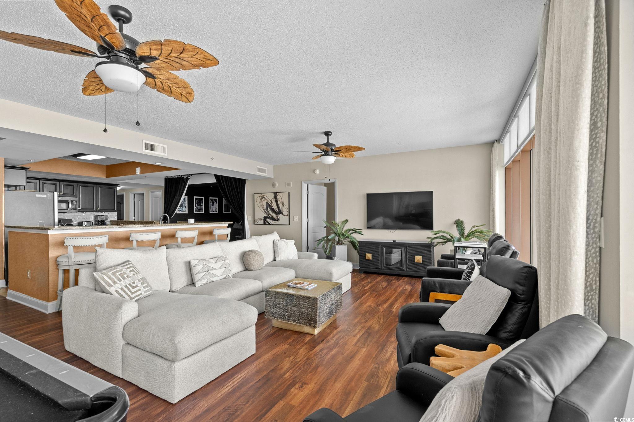 100 North Beach Boulevard, Unit 1803 North Myrtle Beach, SC 29582 - Photo 10 of 35 Living room with ceiling fan, dark wood-style flooring, and a textured ceiling