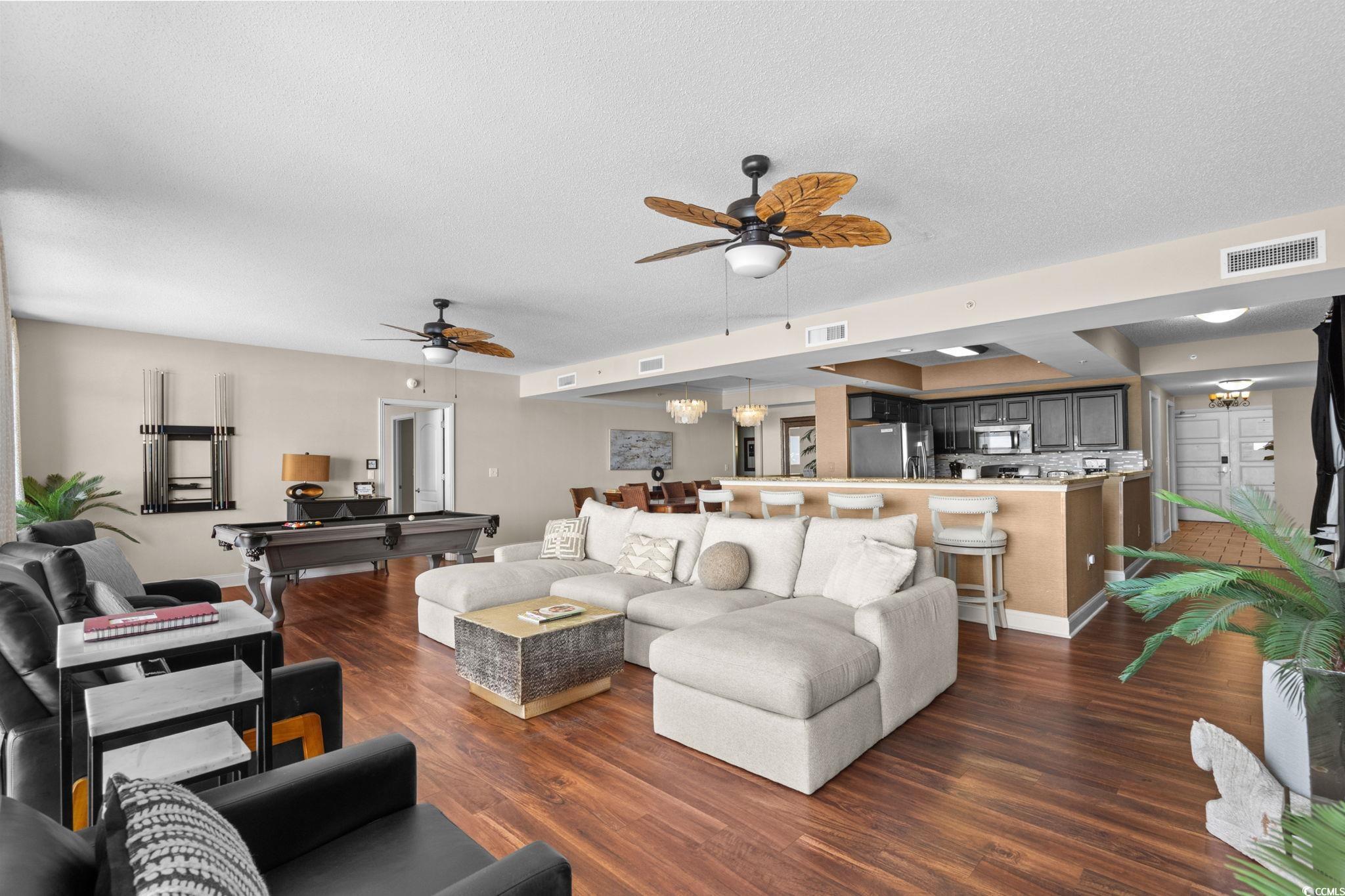 100 North Beach Boulevard, Unit 1803 North Myrtle Beach, SC 29582 - Photo 11 of 35 Living area with dark wood-style floors, ceiling fan, a chandelier, billiards table, and a textured ceiling