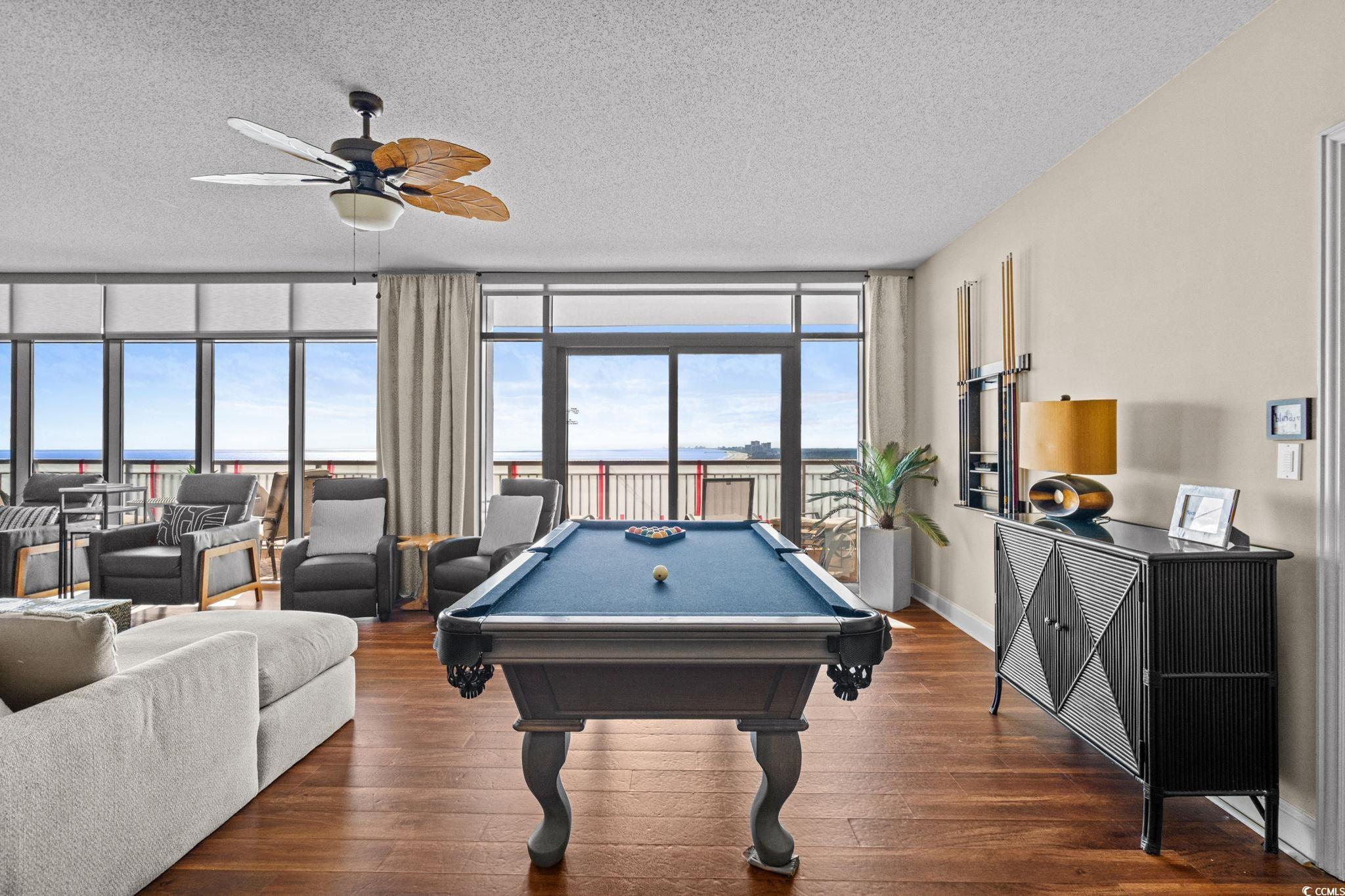 100 North Beach Boulevard, Unit 1803 North Myrtle Beach, SC 29582 - Photo 12 of 35 Game room with floor to ceiling windows, billiards table, dark wood-type flooring, a textured ceiling, and ceiling fan