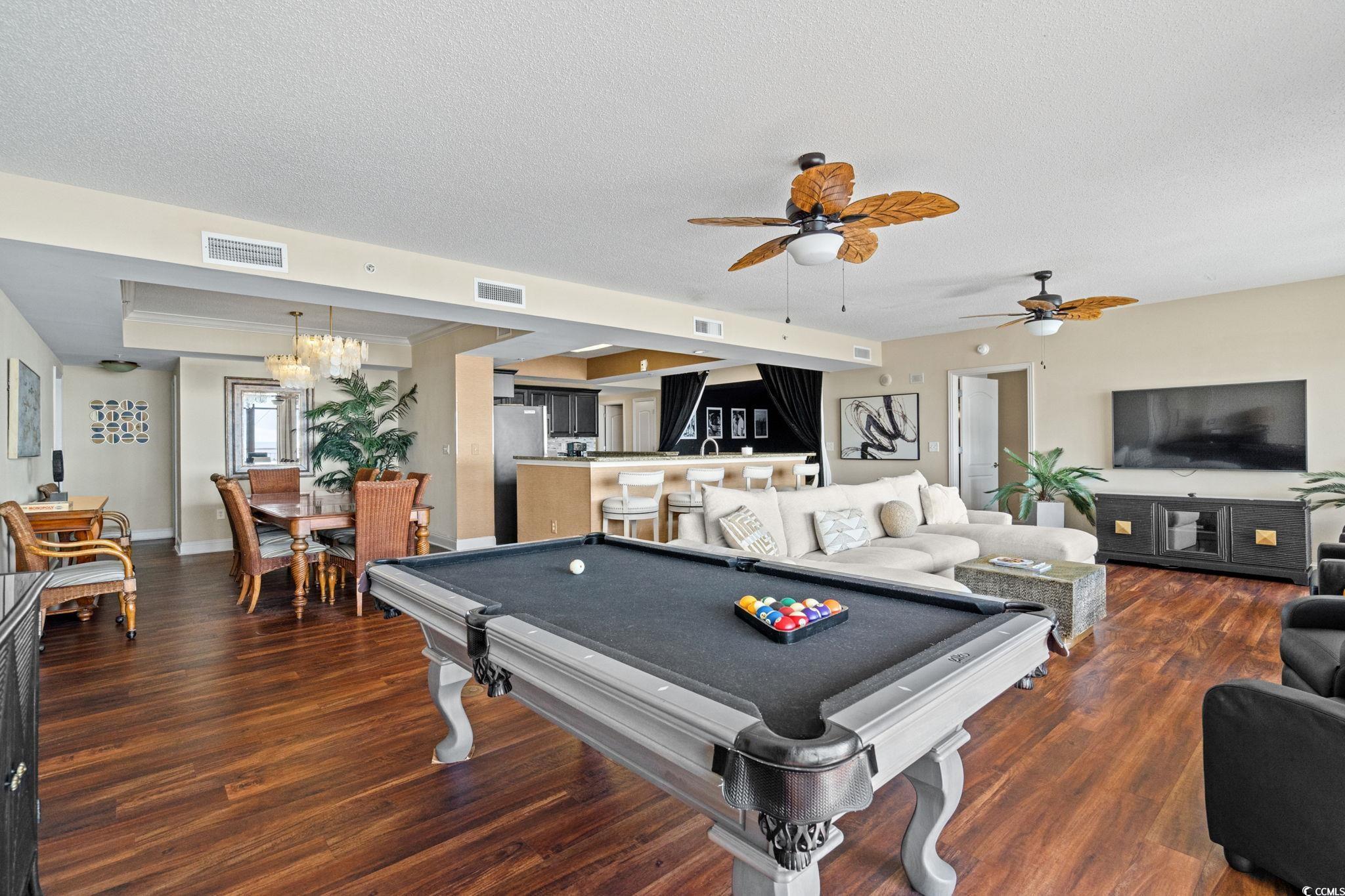 100 North Beach Boulevard, Unit 1803 North Myrtle Beach, SC 29582 - Photo 13 of 35 Rec room with dark wood-style flooring, a textured ceiling, pool table, a tray ceiling, and ceiling fan