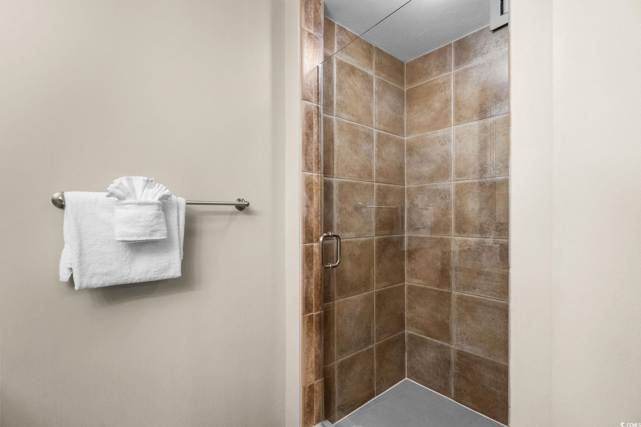 100 North Beach Boulevard, Unit 1803 North Myrtle Beach, SC 29582 - Photo 23 of 35 Bathroom with a garden tub and a tile shower