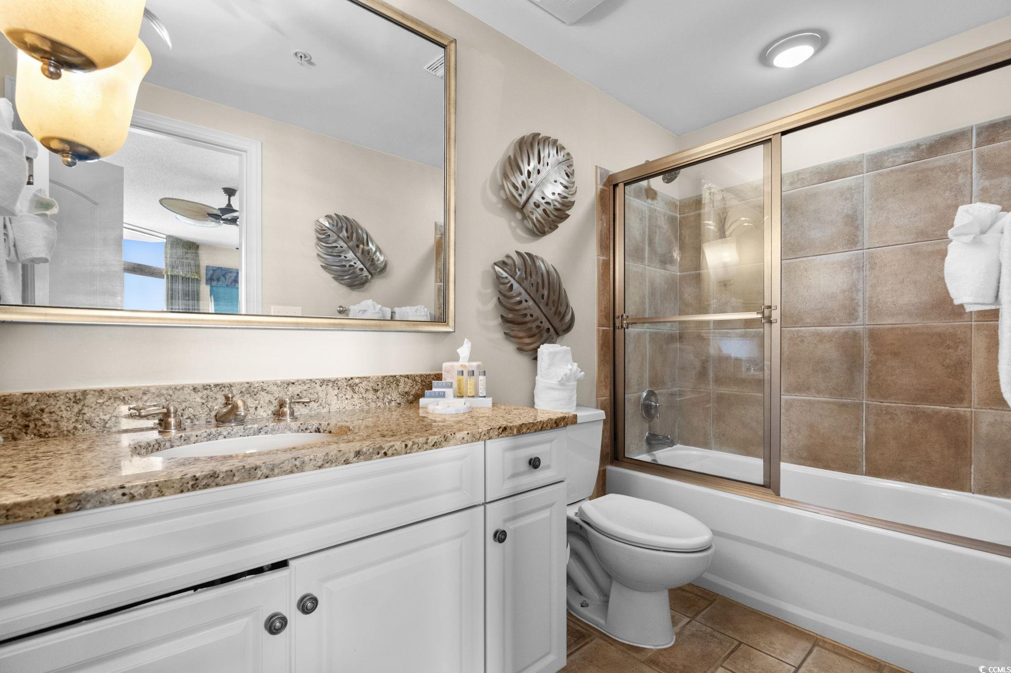 100 North Beach Boulevard, Unit 1803 North Myrtle Beach, SC 29582 - Photo 25 of 35 Bedroom featuring dark wood-type flooring, ceiling fan, and a textured ceiling