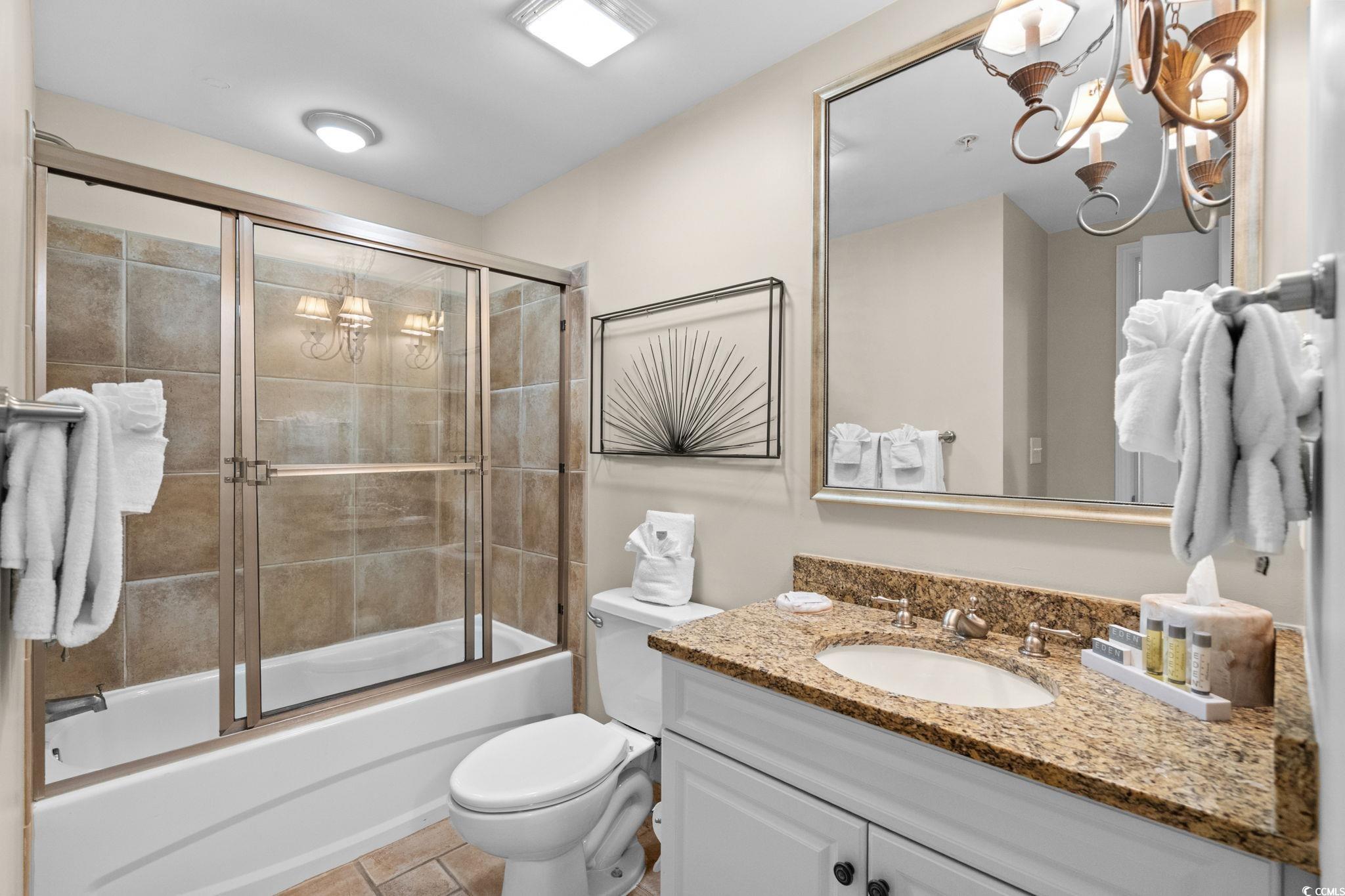 100 North Beach Boulevard, Unit 1803 North Myrtle Beach, SC 29582 - Photo 26 of 35 Full bath with vanity, combined bath / shower with glass door, light tile patterned floors, and a ceiling fan