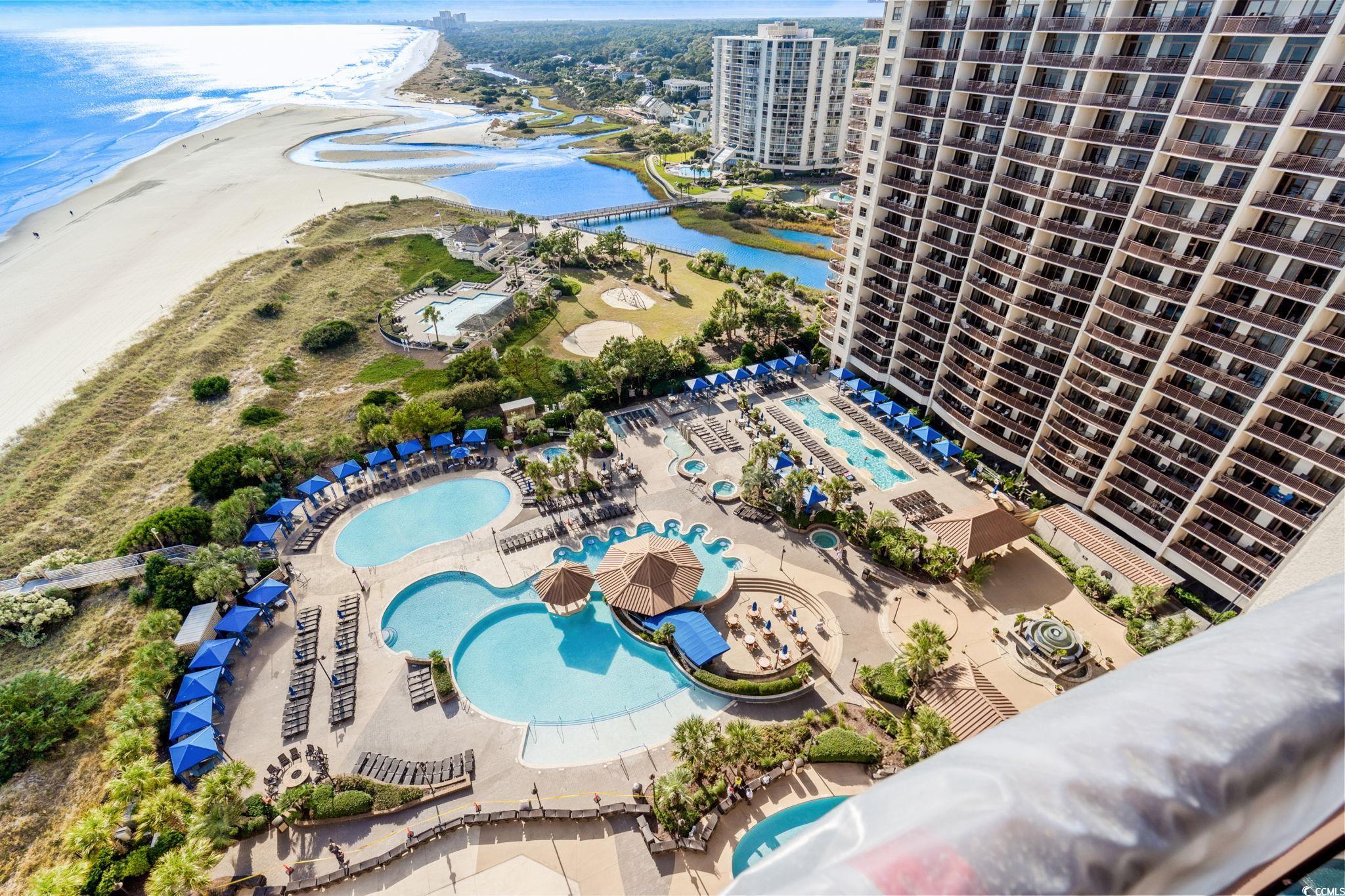 100 North Beach Boulevard, Unit 1803 North Myrtle Beach, SC 29582 - Photo 6 of 35 Aerial view of a pool area and a nearby body of water