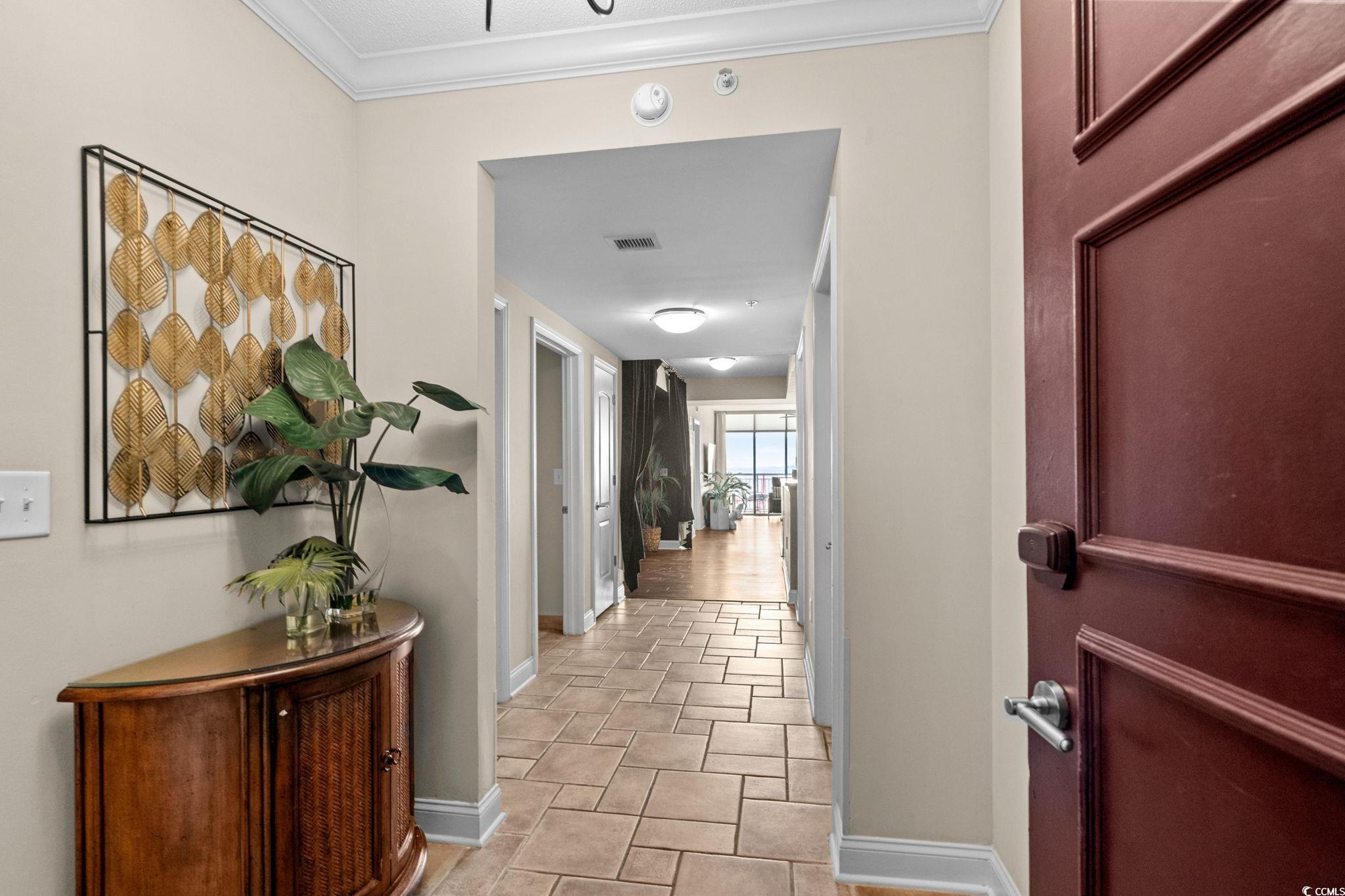 100 North Beach Boulevard, Unit 1803 North Myrtle Beach, SC 29582 - Photo 7 of 35 Corridor featuring crown molding and baseboards