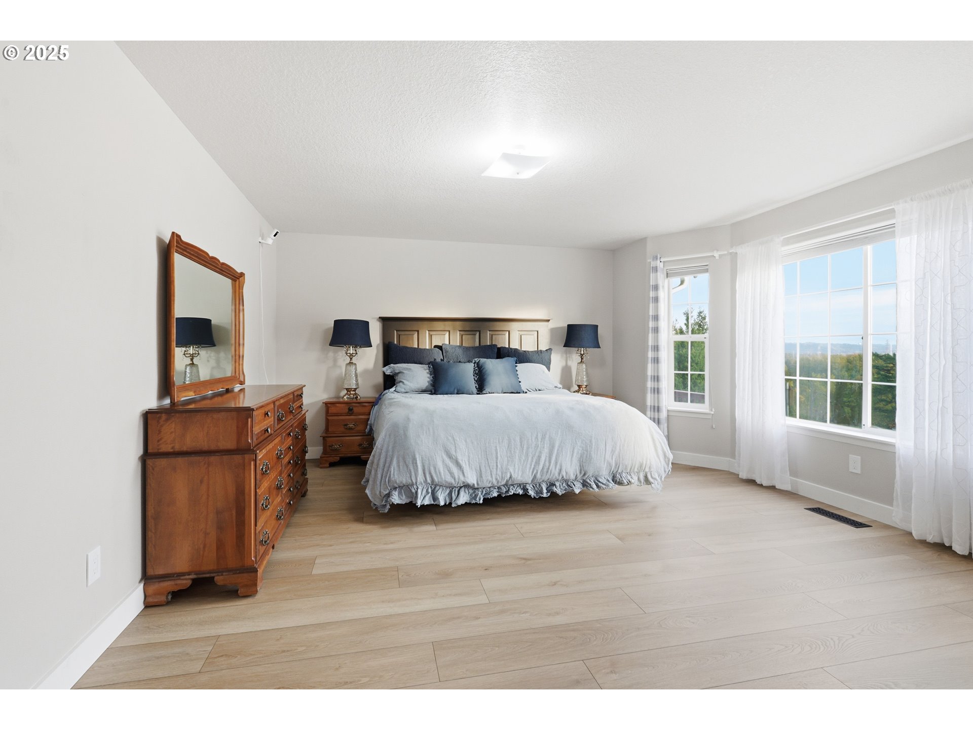 1533 Southwest 7th Circle Camas, WA 98607 - Photo 11 of 27 a bedroom with a bed and wooden floor