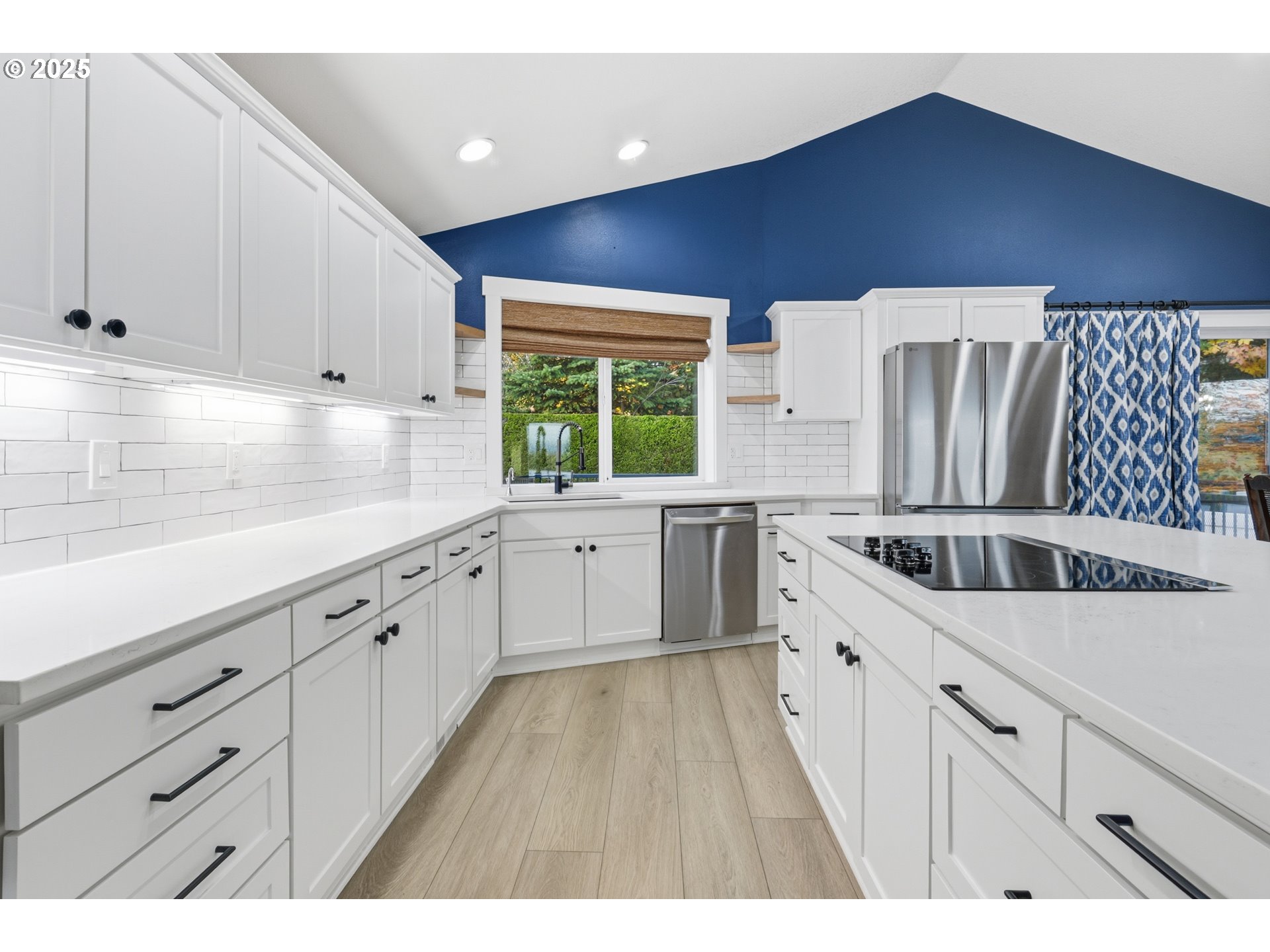 1533 Southwest 7th Circle Camas, WA 98607 - Photo 7 of 27 a kitchen with granite countertop white cabinets a sink dishwasher and a stove with wooden floor