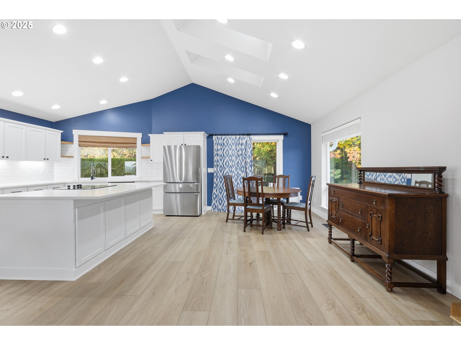 1533 Southwest 7th Circle Camas, WA 98607 - Photo 8 of 27 a kitchen with stainless steel appliances granite countertop a refrigerator a stove a dining table and chairs with wooden floor