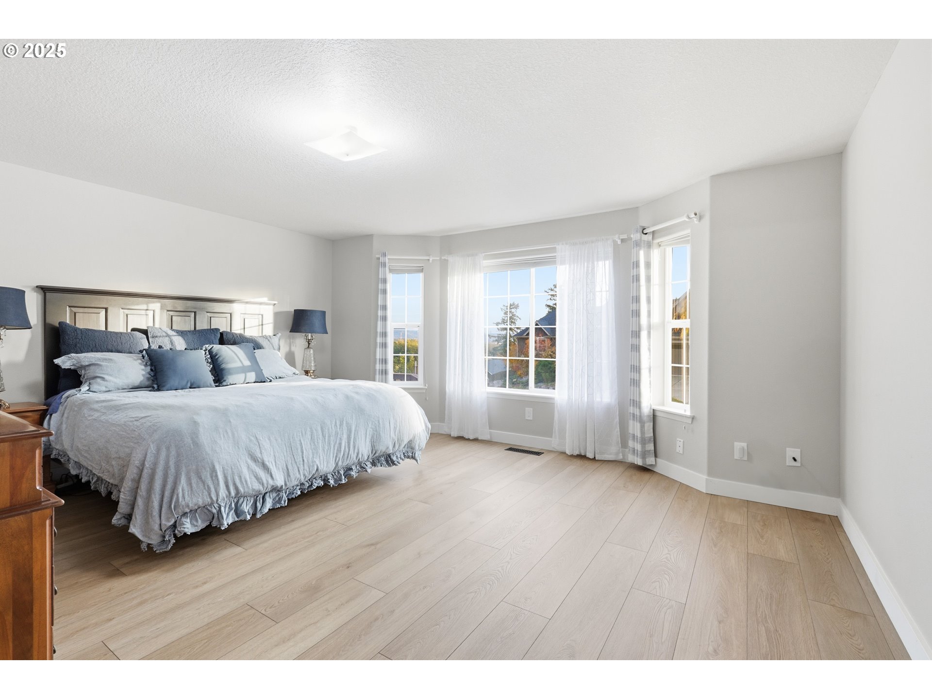 1533 Southwest 7th Circle Camas, WA 98607 - Photo 10 of 27 a spacious bedroom with a bed and wooden floor