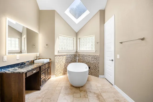 a kitchen with a granite countertop sink a stove and a window