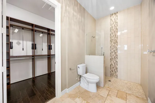 a bathroom with a toilet a sink and shower
