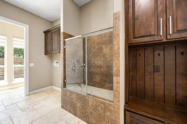 a bathroom with a granite countertop window and a shower