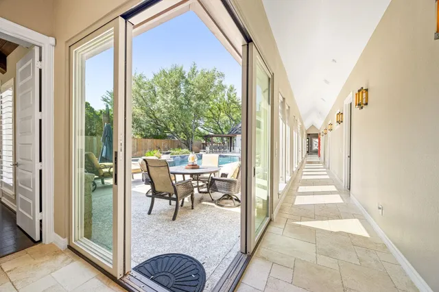 a view of a hallway with wooden floor and furniture