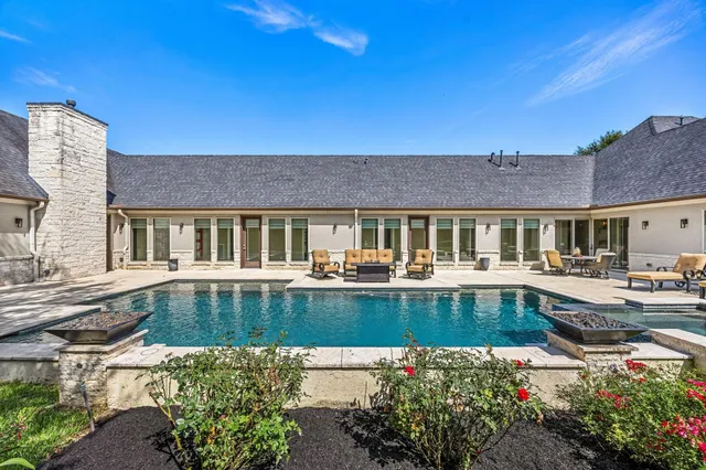 a view of a house with swimming pool and sitting area
