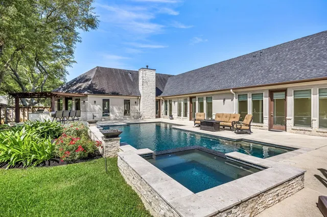 a view of house with swimming pool outdoor seating