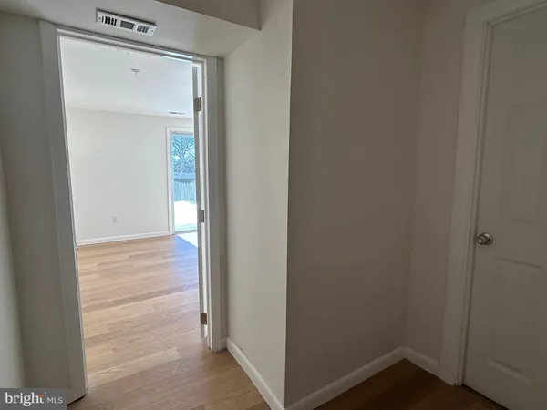 a view of a hallway with wooden floor