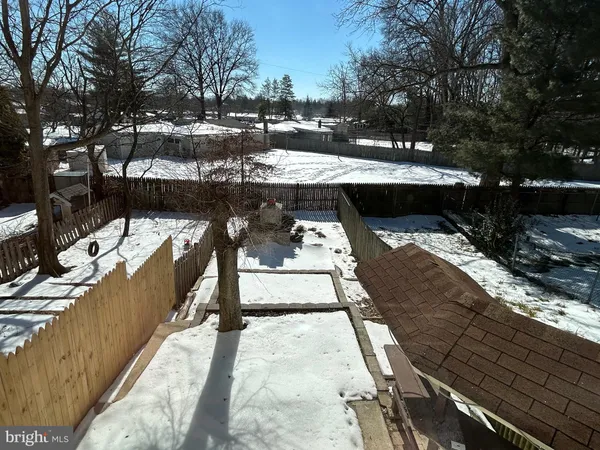 a view of a swimming pool with a patio and fire pit