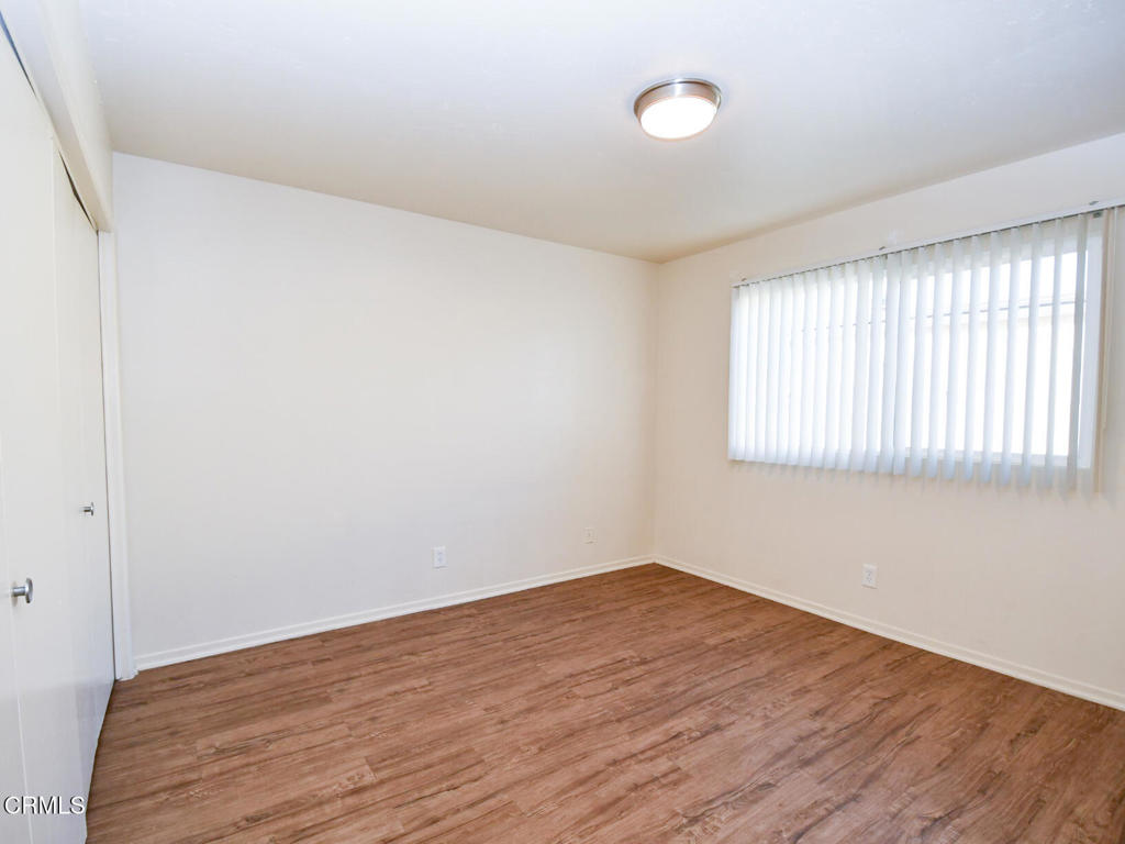 5009 Nautilus Street, Unit 14 Oxnard, CA 93035 - Photo 5 of 11 wooden floor in an empty room with a window