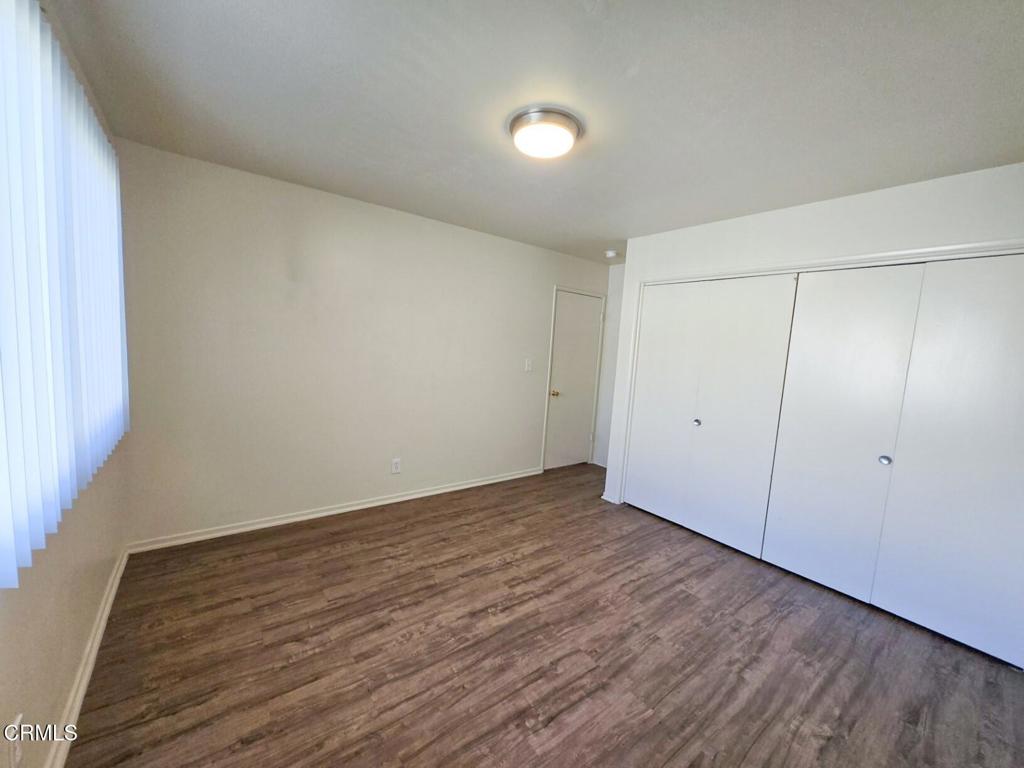 5009 Nautilus Street, Unit 14 Oxnard, CA 93035 - Photo 6 of 11 a view of an empty room with wooden floor