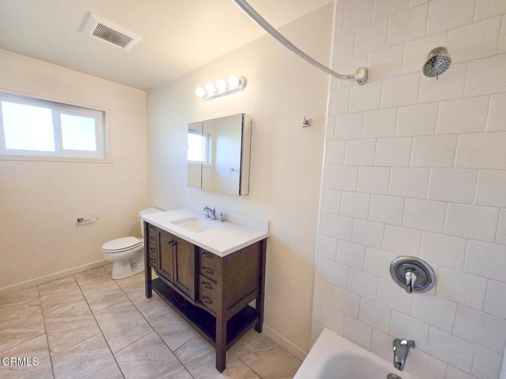 5009 Nautilus Street, Unit 14 Oxnard, CA 93035 - Photo 8 of 11 a bathroom with a sink a toilet and mirror