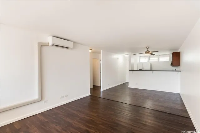 an empty room with wooden floor and a window