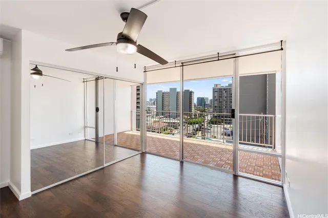 a view of a living room hardwood floor and ceiling fan