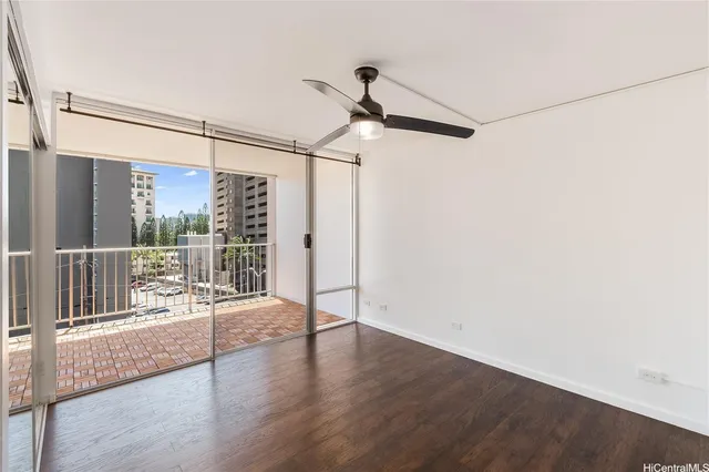a view of hallway with wooden floor and windows