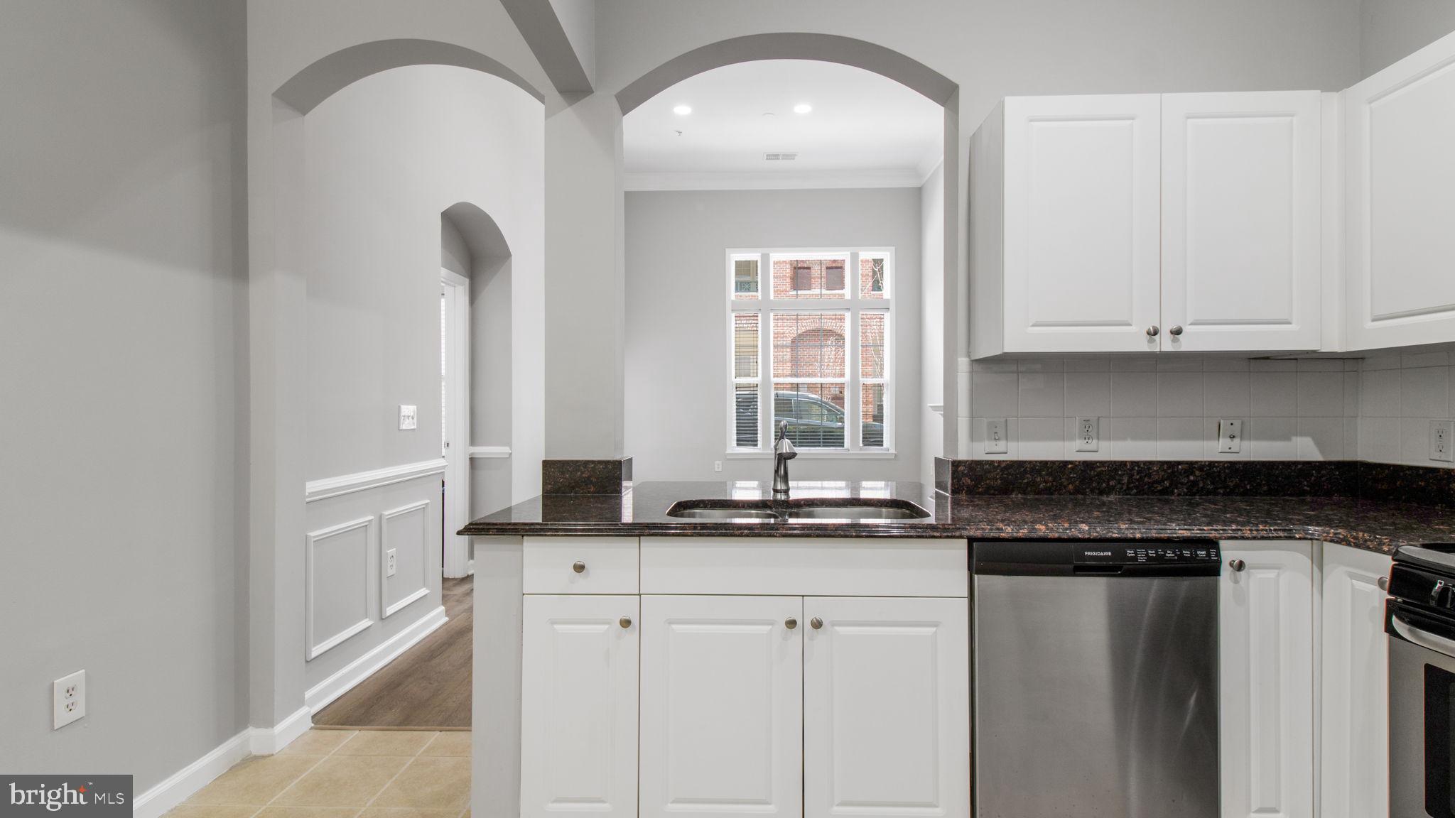 3 Arch Place, Unit 130 Gaithersburg, MD 20878 - Photo 12 of 45 a kitchen with granite countertop white cabinets and sink