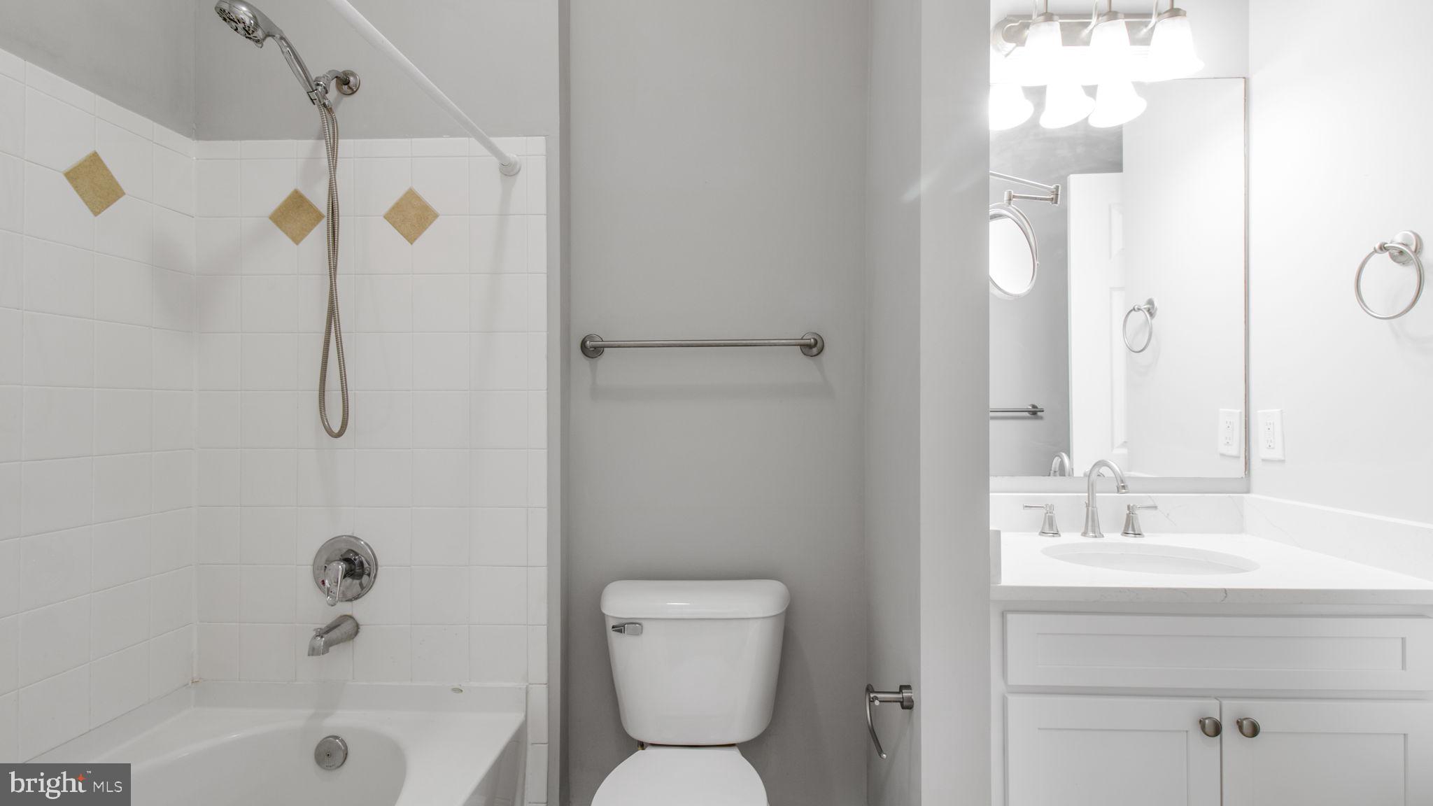 3 Arch Place, Unit 130 Gaithersburg, MD 20878 - Photo 14 of 45 a bathroom with a shower a sink a toilet and shower