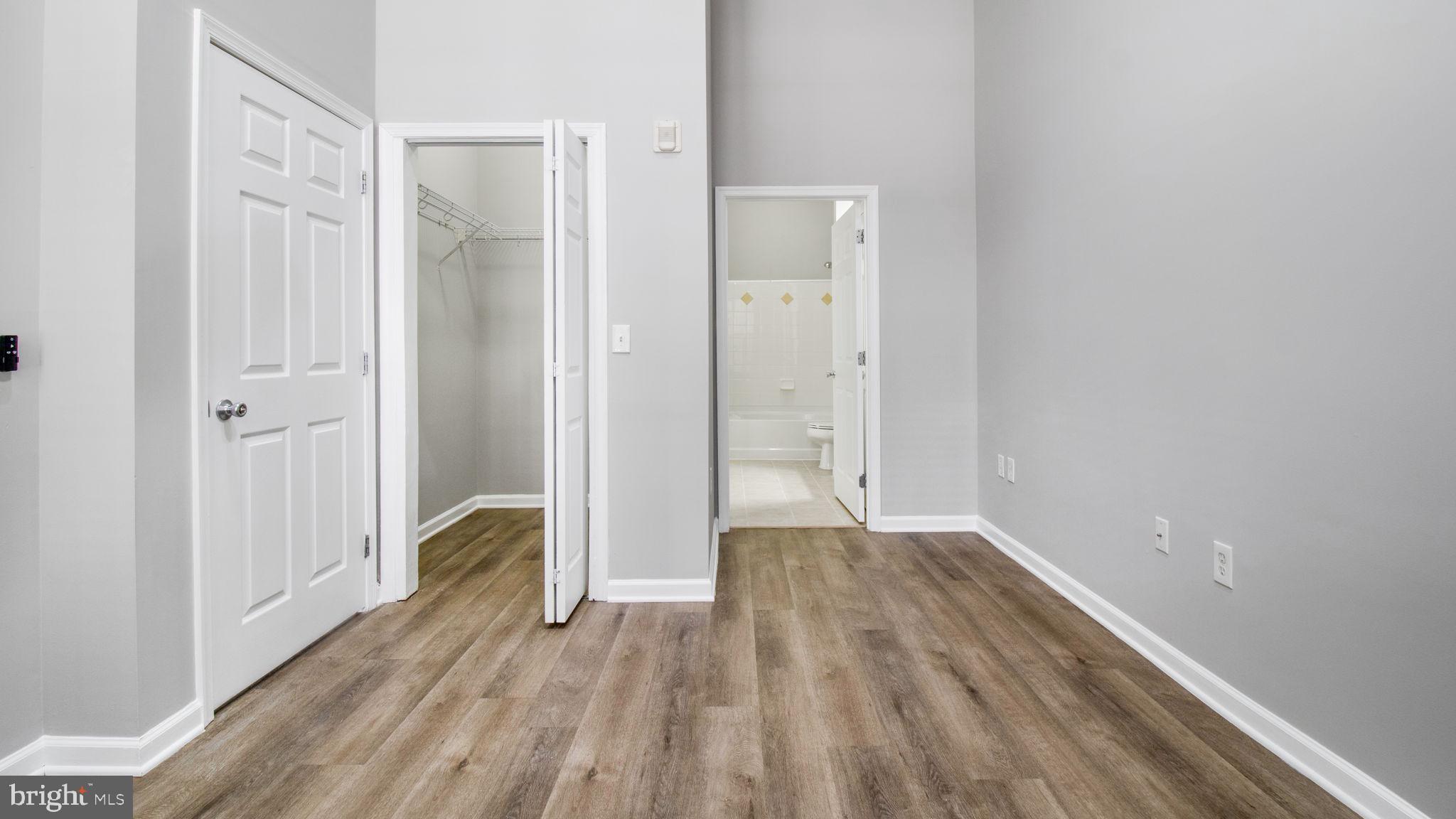 3 Arch Place, Unit 130 Gaithersburg, MD 20878 - Photo 20 of 45 a view of a room with wooden floor and a bathroom