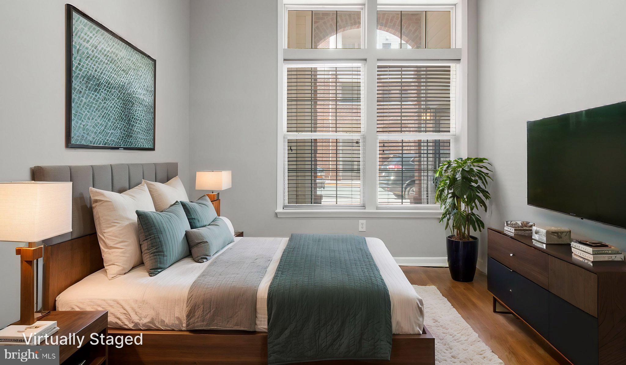 3 Arch Place, Unit 130 Gaithersburg, MD 20878 - Photo 21 of 45 a bedroom with a bed television on desk and a window