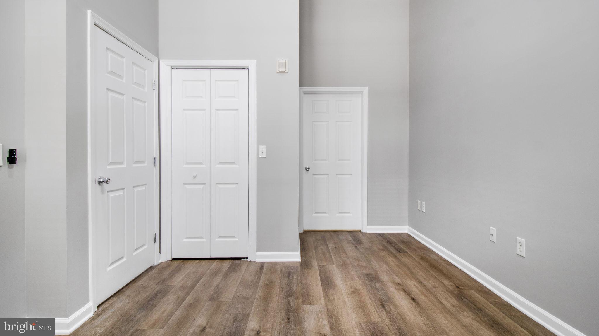 3 Arch Place, Unit 130 Gaithersburg, MD 20878 - Photo 24 of 45 a view of an empty room with wooden floor