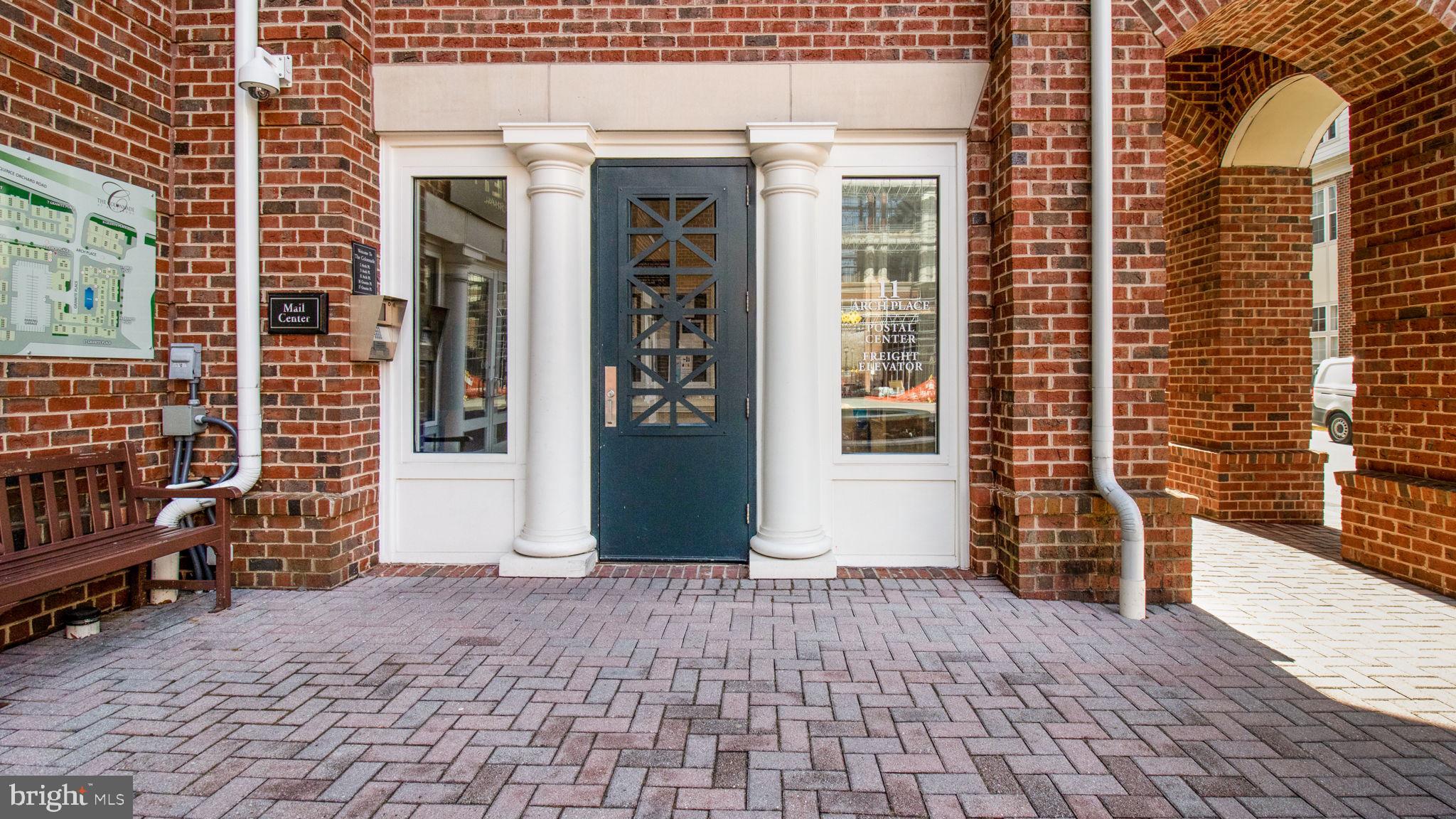 3 Arch Place, Unit 130 Gaithersburg, MD 20878 - Photo 32 of 45 a view of a brick house with large windows