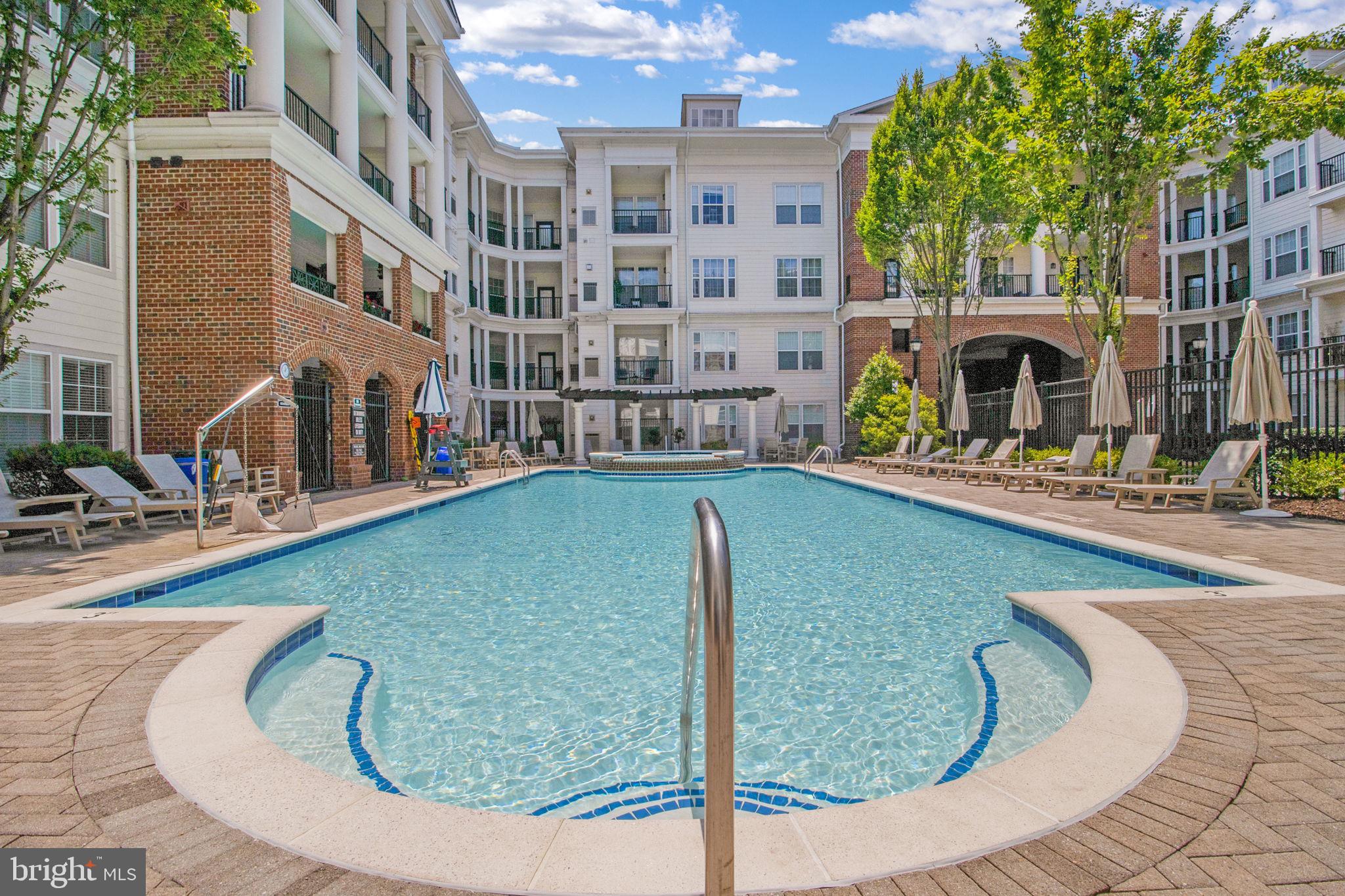3 Arch Place, Unit 130 Gaithersburg, MD 20878 - Photo 34 of 45 a view of a swimming pool with outdoor seating