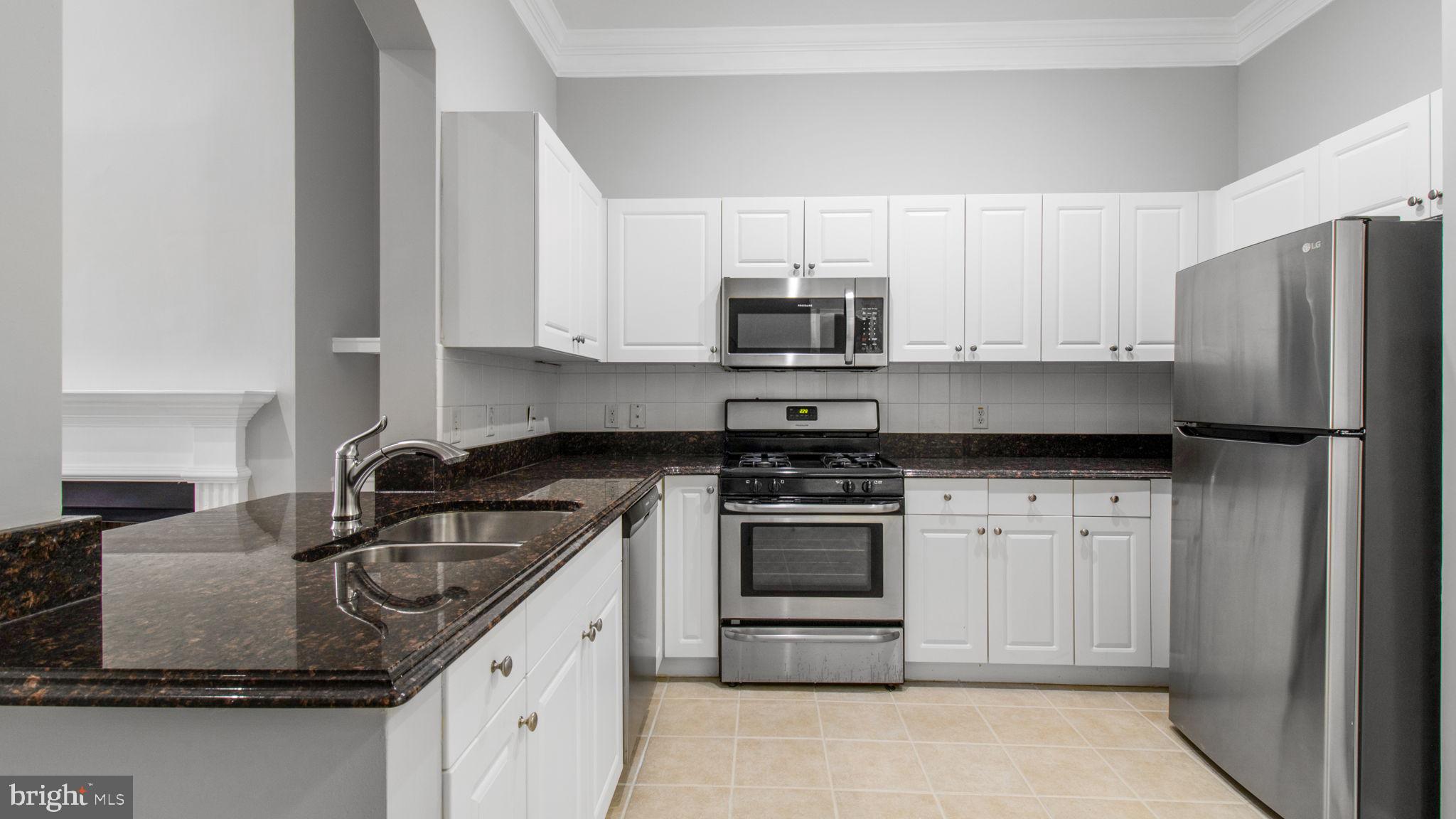 3 Arch Place, Unit 130 Gaithersburg, MD 20878 - Photo 10 of 45 a kitchen with granite countertop a stove sink and refrigerator