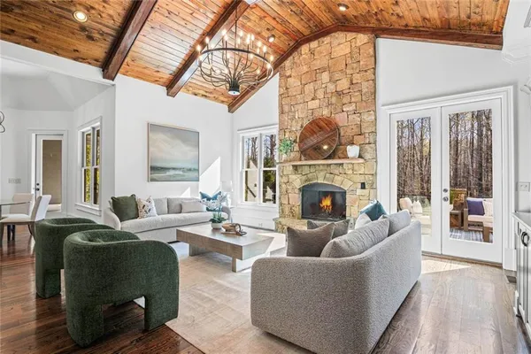 a living room with furniture and a floor to ceiling window