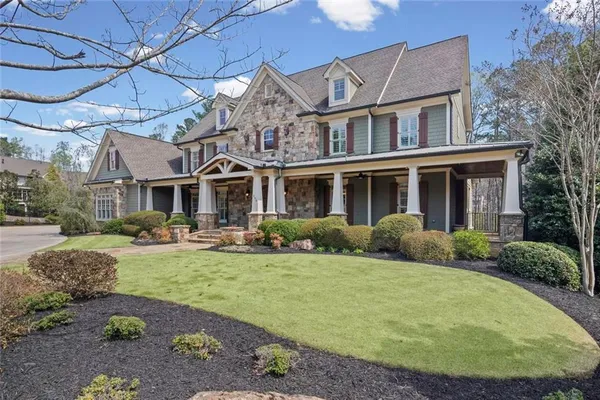 a view of a house with a yard and sitting area