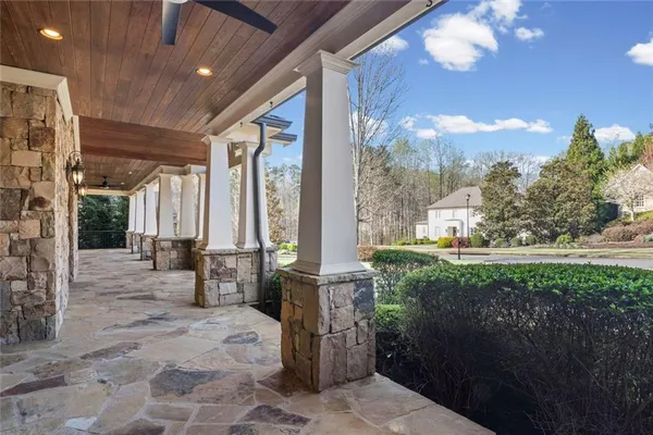 a living room with furniture a chandelier and a fireplace